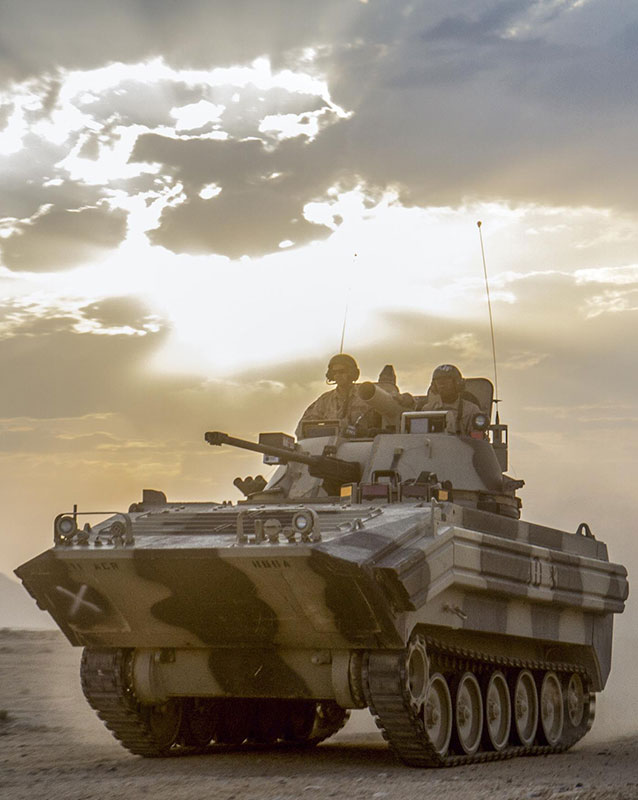 An infantry vehicle rolls across the barren desert during a training event in the John Wayne Foothills of the National Training Center in Fort Irwin, Calif., July 31, 2016. The purpose of this exercise was to test a combat scenario in a simulated real-time environment. Army photo by Pvt. Austin Anyzeski